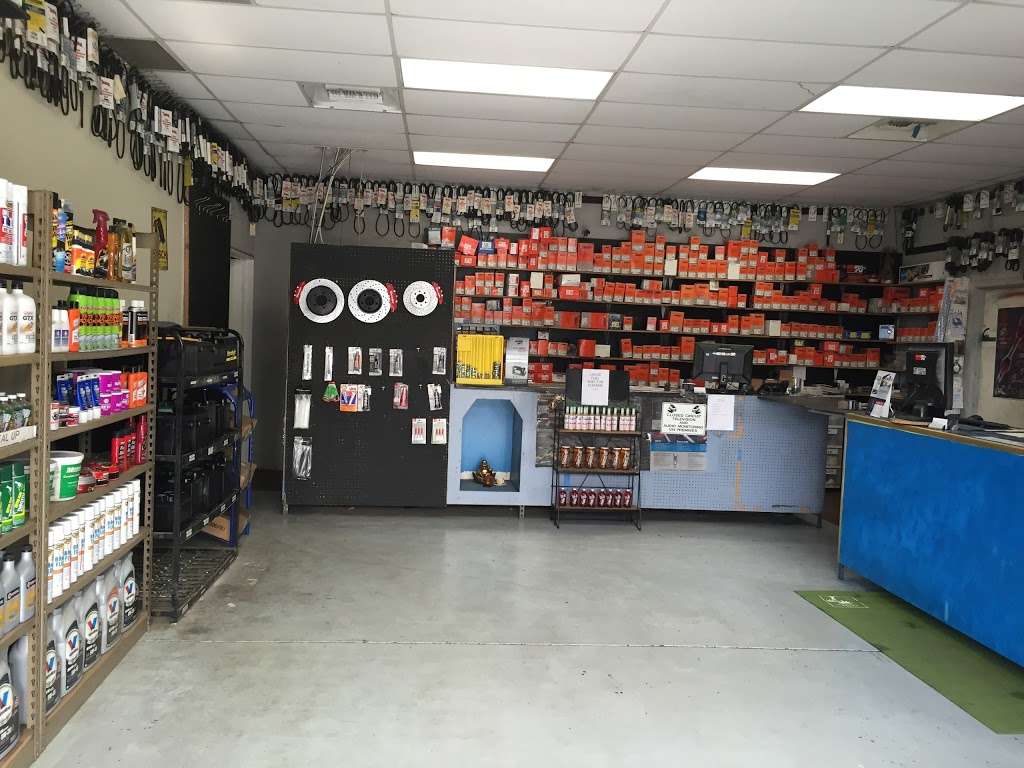 Wide interior view of ACR Auto Parts with stocked shelves and front counter